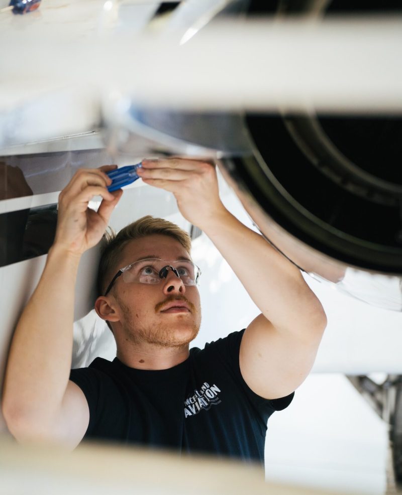 Aviation Maintenance mechanic working on an airplane