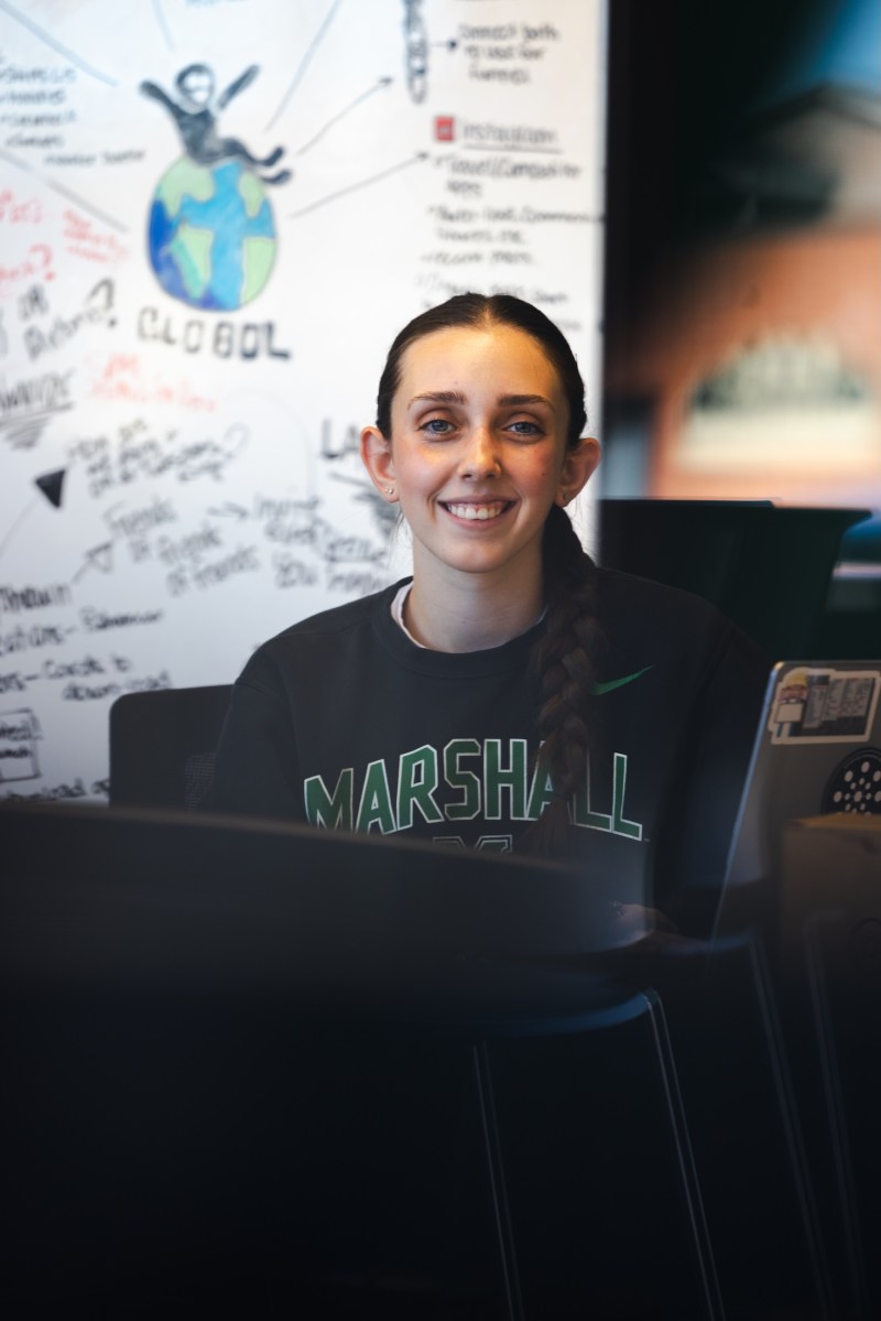 student working int he iCenter and smiling at the camera