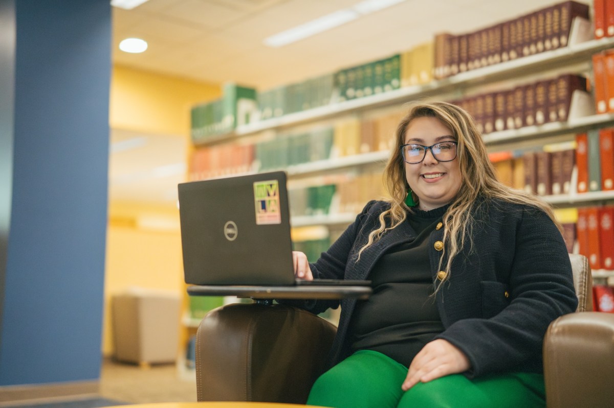 student working on a laptop in the library