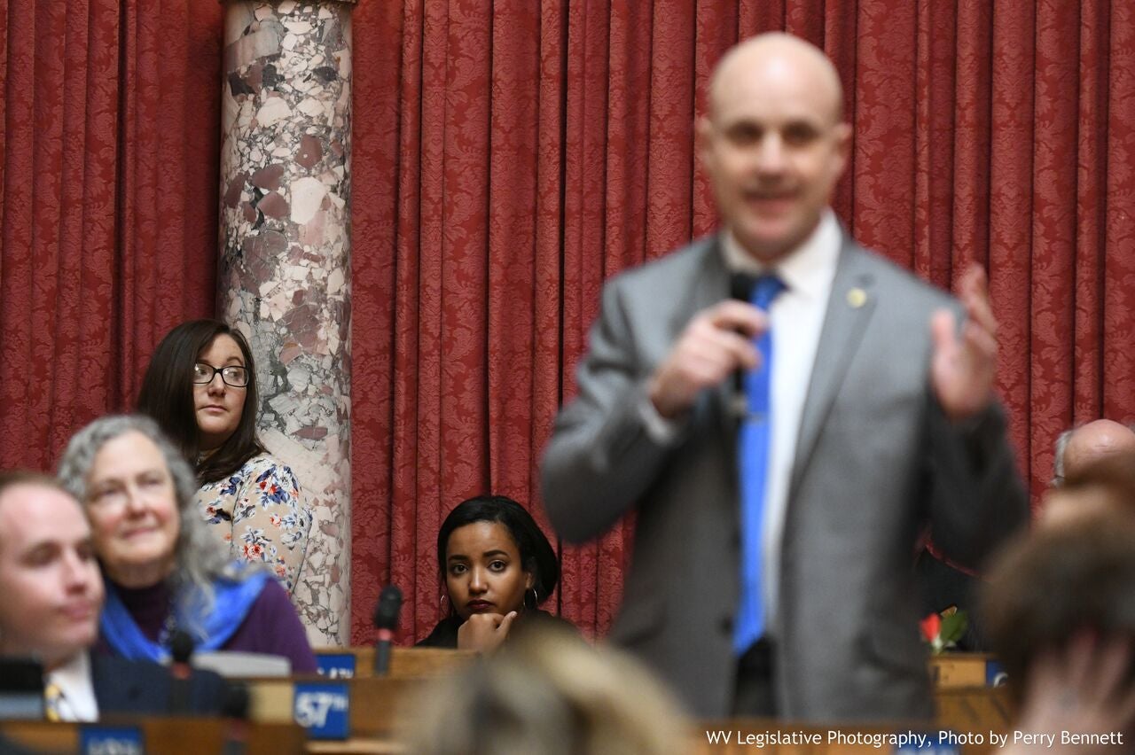 Interns Karenann Flouhouse and Danite Belay listening to Del. Jim Butler, WV House of Delegates