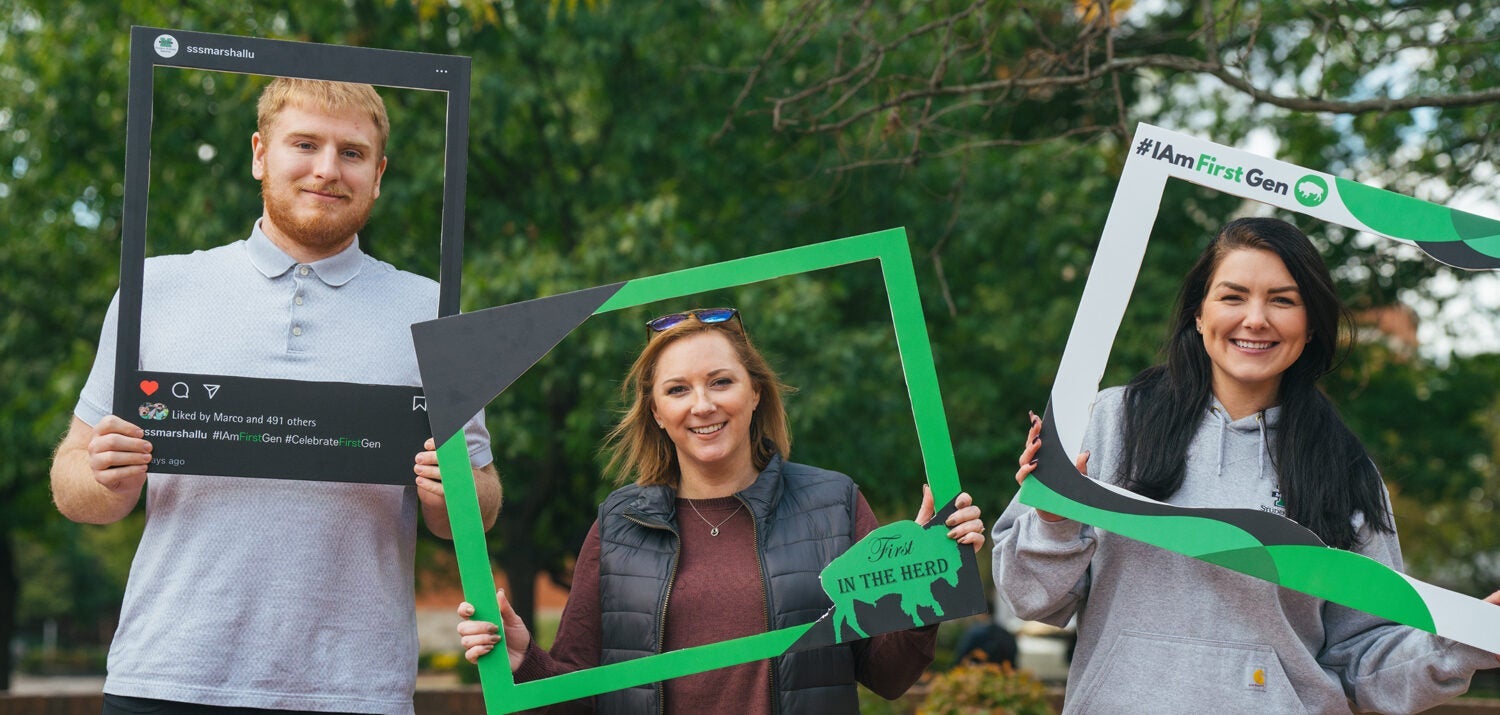 Student Support Services staff pose for a photo while holding First Generation photo frames