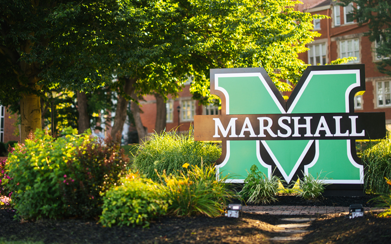Marshall University sign in front of Old Main on Marshall's Huntington campus