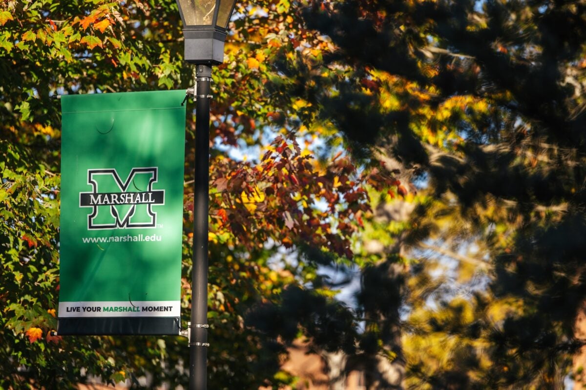 green Marshall flag on campus in the fall