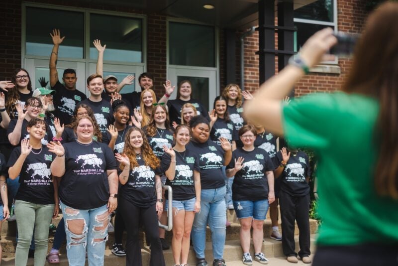FAM mentors posing for a photo and smiling on the stairs of East Hall