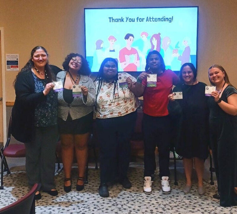 group of people smiling at the camera after completing a presentation