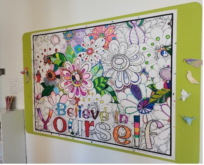 Believe in Yourself collaborative coloring sheet on the wall in East Hall