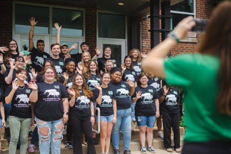 FAM mentors posing for a photo and smiling on the stairs of East Hall