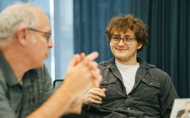 A professor and student discuss academic plans at Marshall University