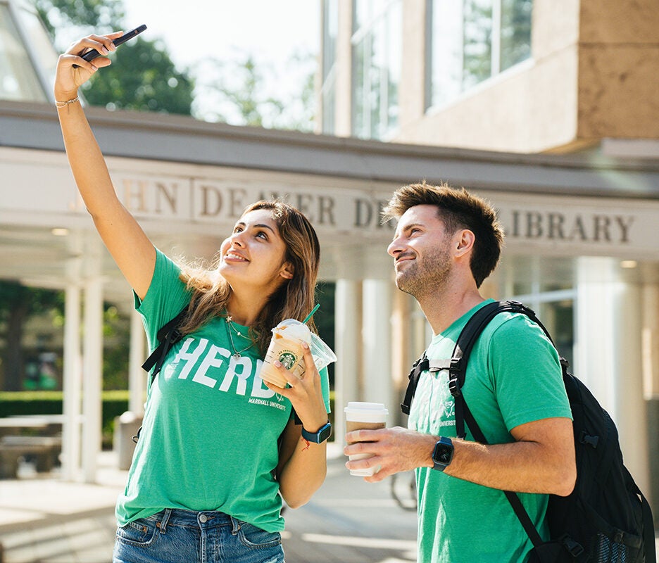 Students take a selfie in front of Marshall's Drinko Library