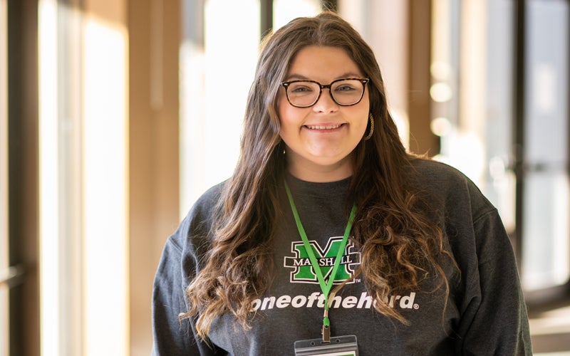 A Marshall University Tour Guide smiles at the camera before a tour