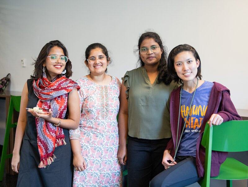 A group of students stand together smiling