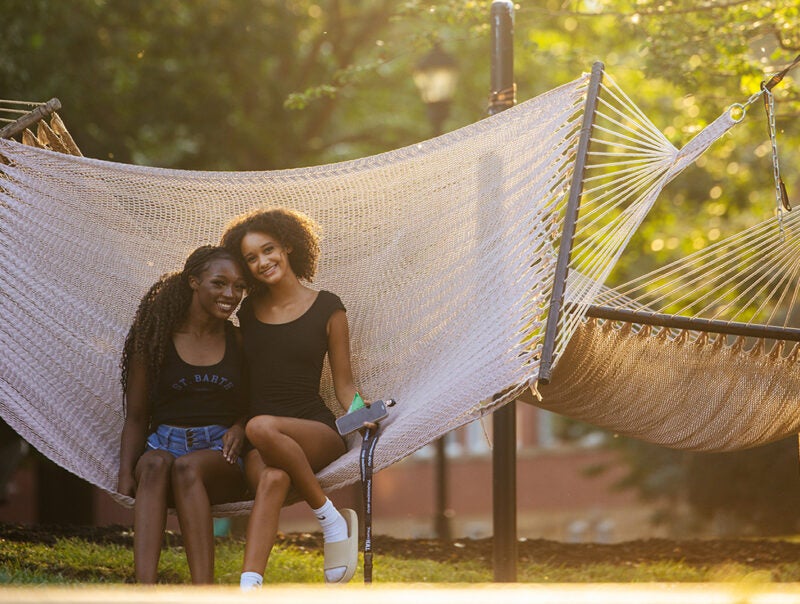Two students sit together on a hammock on Marshall University's Huntington campus