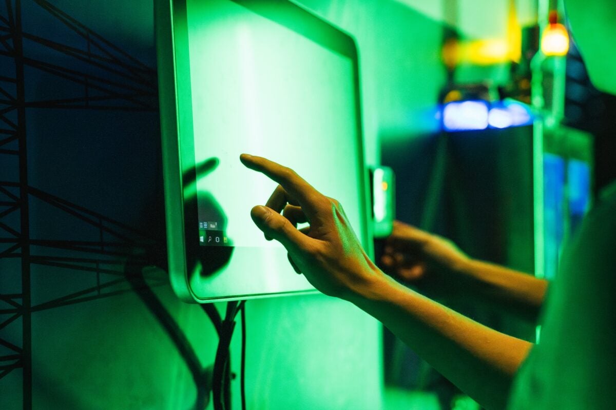 Photo of student using touch screen in Cyber Security facility