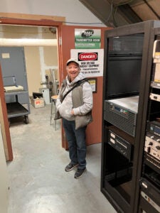Missy stands in front of the new transmitter.