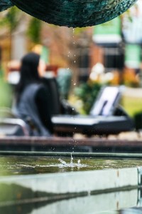 Water droplets fall from the Memorial Student Center fountain as students gather in the background.