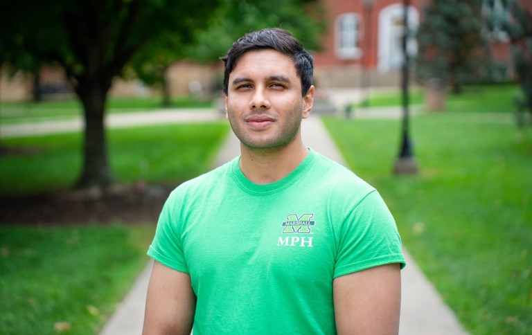 MPH student standing in front of Old Main