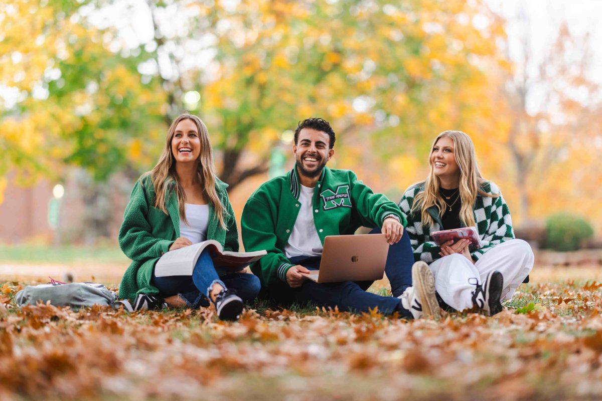 students studying on campus in the fall