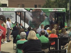 Image of people sitting looking at new bus graphic