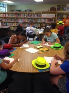 Image of students working on projects around a table