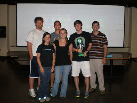 Scott Day's group posing with their trophy after winning the annual Wii bowling tournament during the ice cream social.