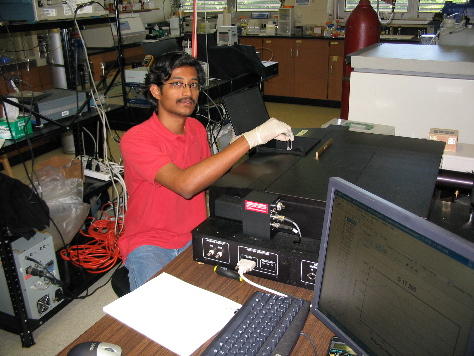 student working on a ISS PC1 Photom Counting Spectrofluorometer (1998)