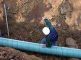 Photo from Sedimentation and Stratigraphy field trip showing students in the trench of an in-ground pipeline installation