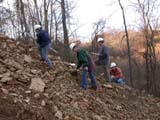 Photo from Sedimentation and Stratigraphy field trip showing students surveying a forest
