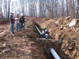 Photo from Sedimentation and Stratigraphy field trip showing students around an in-ground pipeline installation