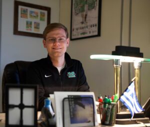 Erik Cochrane sits at his desk in the Marshall University SGA office.