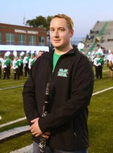 Zach Falther participating in the alumni band on the football field