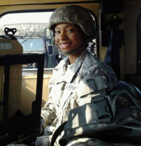 Andrea Gray wears US Army uniform while inside a military vehicle.
