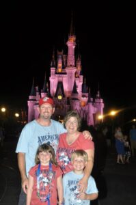 Kelci Armstead and her family stand in front of the Walt Disney World castle at night in 2013.